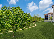Thumbnail 55 of 62 - a path through the grass next to a building