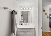 Thumbnail 9 of 54 - A bathroom with a white sink and a mirror.