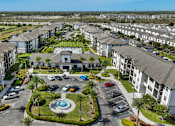 Thumbnail 37 of 42 - A large residential complex with a swimming pool in the center.