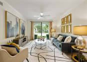 Thumbnail 41 of 48 - a living room with a couch and chairs and a ceiling fan