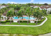 Thumbnail 48 of 48 - a mansion with a swimming pool surrounded by palm trees