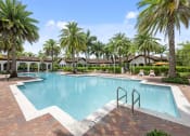 Thumbnail 12 of 48 - a large swimming pool with palm trees in front of a house