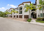Thumbnail 46 of 48 - a large white building with palm trees in front of it