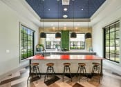 Thumbnail 26 of 48 - a kitchen with an island and stools in front of windows