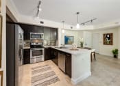 Thumbnail 40 of 48 - a kitchen with stainless steel appliances and a white island
