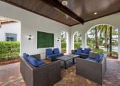 Thumbnail 13 of 48 - a covered patio with furniture and a pool in the background