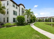 Thumbnail 47 of 48 - the preserve at city center walkway in front of apartment buildings and a lake