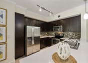 Thumbnail 37 of 48 - a kitchen with stainless steel appliances and a white counter top