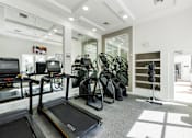 Thumbnail 9 of 40 - A gym with treadmills, exercise bikes, and other equipment.