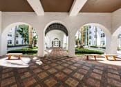 Thumbnail 13 of 40 - A courtyard with a tiled floor and arches.