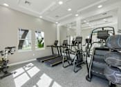 Thumbnail 11 of 40 - A spacious gym with treadmills, exercise bikes, and other equipment.