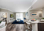 Thumbnail 29 of 40 - A modern kitchen with a dining table and chairs.