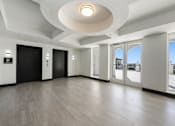 Thumbnail 14 of 40 - A spacious room with a black door and a white ceiling.