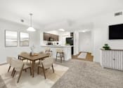 Thumbnail 19 of 33 - A modern dining room with a wooden table and chairs.