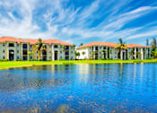 Thumbnail 1 of 33 - A row of houses with red roofs and white walls are reflected in the water.