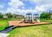 Thumbnail 33 of 33 - A playground with a slide, swings, and a gazebo.