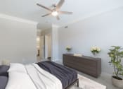 Thumbnail 9 of 30 - a bedroom with a bed and a ceiling fan