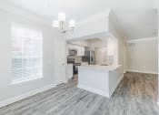 Thumbnail 6 of 30 - an open kitchen and living room with a large window