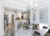 Thumbnail 3 of 30 - an open kitchen and dining room with a marble table and chairs