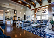 Thumbnail 17 of 28 - a living room with couches and chairs and a kitchen