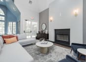 Thumbnail 13 of 20 - a living room with a white couch and a fireplace