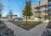 Thumbnail 33 of 33 - an empty playground with chairs in front of an apartment building