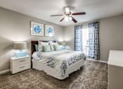 Thumbnail 15 of 29 - a bedroom with a bed and a ceiling fan