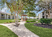 Thumbnail 25 of 29 - a view of the courtyard of a building with trees and grass