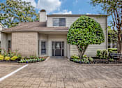 Thumbnail 29 of 29 - the front of a white house with a driveway and a tree