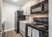 Thumbnail 13 of 29 - the kitchen of a home with stainless steel appliances and white cabinets
