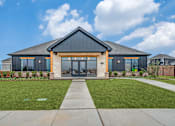 Thumbnail 20 of 20 - A modern house with a black roof and glass windows.