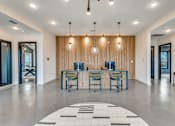 Thumbnail 14 of 20 - A modern room with a long table and chairs.