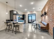 Thumbnail 18 of 20 - A modern kitchen with a bar area and seating.