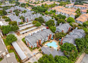Thumbnail 33 of 42 - A bird's eye view of a residential area with houses and a swimming pool.