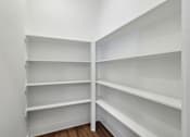 Thumbnail 25 of 38 - Empty white shelves in a room.
