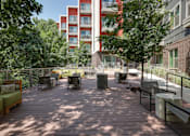 Thumbnail 17 of 36 - A wooden deck with chairs and a table in the middle of it.