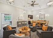 Thumbnail 23 of 26 - A living room with grey couches and a wooden coffee table.