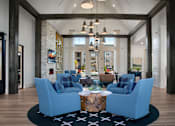 Thumbnail 20 of 47 - A living room with blue chairs and a coffee table.