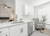 Thumbnail 10 of 35 - a white kitchen with a sink and a window