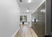 Thumbnail 25 of 32 - a long hallway with a closet and a ceiling fan