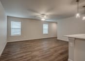 Thumbnail 6 of 19 - an empty living room with a ceiling fan