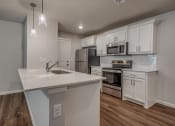 Thumbnail 7 of 19 - a kitchen with white cabinets and a white counter top
