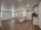 Thumbnail 9 of 19 - a kitchen and living room with hardwood floors