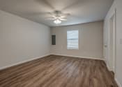 Thumbnail 12 of 19 - a bedroom with hardwood floors and a ceiling fan