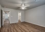 Thumbnail 15 of 19 - a bedroom with hardwood floors and a ceiling fan