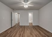Thumbnail 11 of 19 - a bedroom with a ceiling fan and hardwood floors