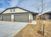Thumbnail 2 of 19 - a home with a gray garage door