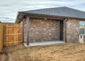 Thumbnail 18 of 19 - a garage with a wooden gate and a brick wall