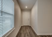 Thumbnail 3 of 19 - a bedroom with a large window and a white door