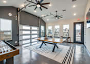 Thumbnail 10 of 15 - A room with a pool table and a view of the outside.